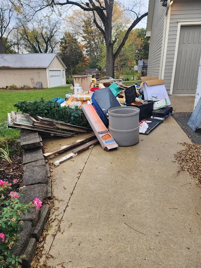 Dumpster being loaded with debris for Estate Cleanout Dumpster Rental in Cherry Hill